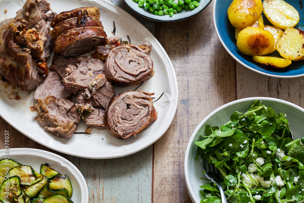Easter meal with roast lamb, potatoes, courgette, garden peas and watercress salad