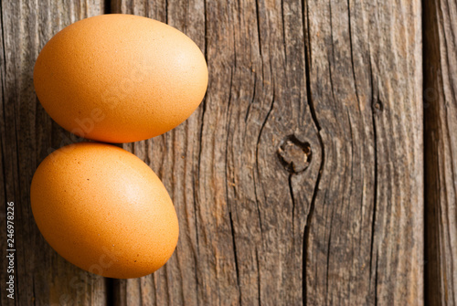 two eggs on weathered wooden table