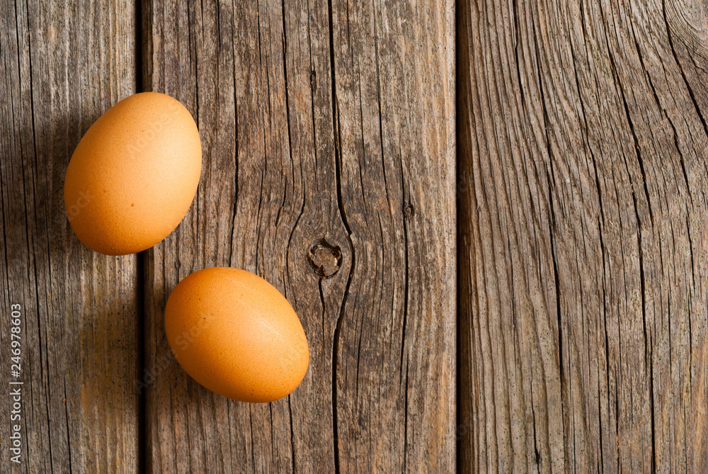 two eggs on weathered wooden table two eggs on weathered wooden table
