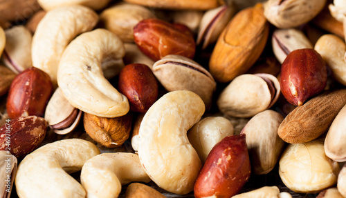 Healthy mix nuts on wooden background. Almonds, hazelnuts, cashews, peanuts, pistachios, brazilian nuts