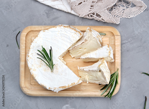 round brie cheese on a wooden board
