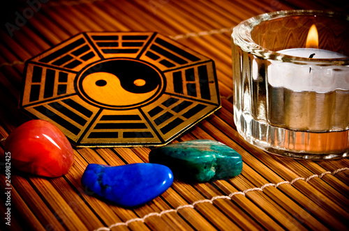 Ying yang symbol with iching I Ching hexagram. healing gem stones and candle  photo