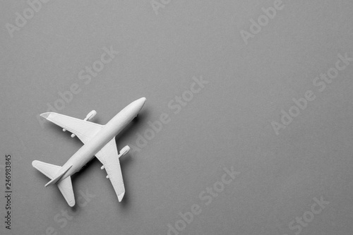 White passenger plane on gray background. Copy space for text.