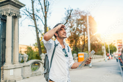 Young guy traveling around Eastern Europe and looking at the map