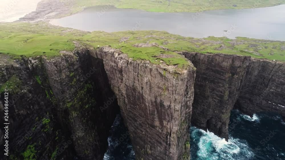Aerial view of tourists English Slave cliff on North Atlantic sea, Faroe island. Aerial view of tourists English Slave cliff on North Atlantic sea, Faroe island.