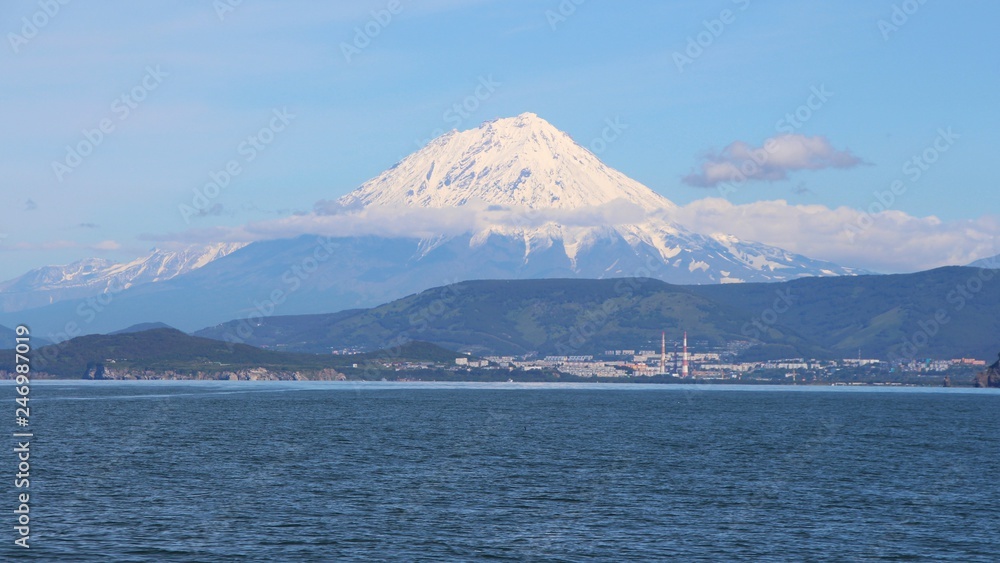 Koryaksky volcano towers over the city of Petropavlovsk-Kamchatsky. Koryaksky or Koryakskaya Sopka is an active volcano on the Kamchatka Peninsula in the Russian Far East. Koryaksky volcano towers over the city of Petropavlovsk-Kamchatsky. Koryaksky or Koryakskaya Sopka is an active volcano on the Kamchatka Peninsula in the Russian Far East.