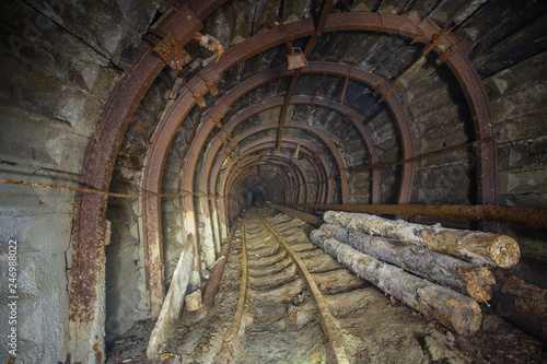 Underground abandoned gold iron ore mine shaft tunnel gallery passage wtih metal timbering