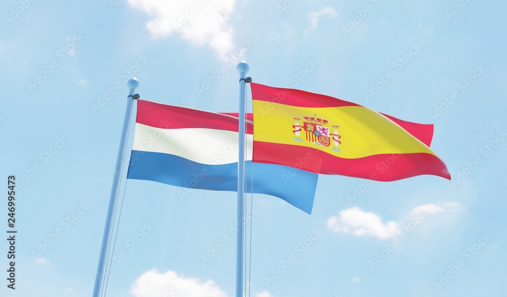 Spain and Netherlands, two flags waving against blue sky. 3d image Spain and Netherlands, two flags waving against blue sky. 3d image