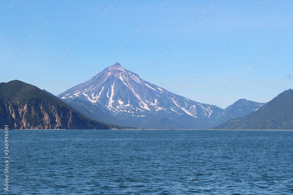 View of Vilyuchinsky volcano (also called Vilyuchik) from tourist boat. It's a stratovolcano in the southern part of Kamchatka Peninsula, Russia.