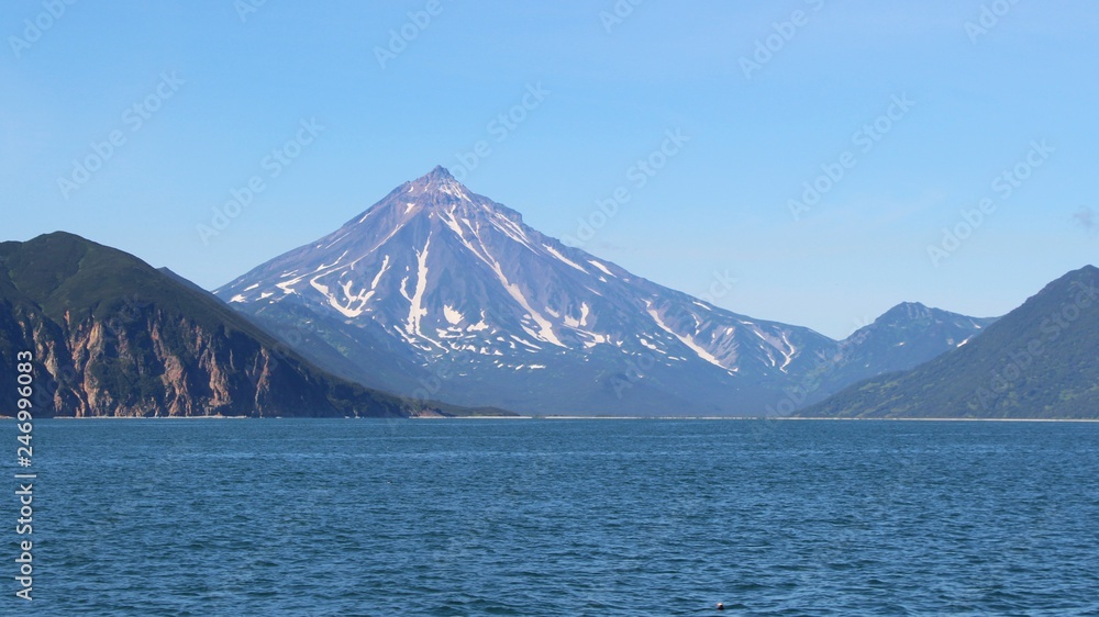 View of Vilyuchinsky volcano (also called Vilyuchik) from tourist boat. It's a stratovolcano in the southern part of Kamchatka Peninsula, Russia. View of Vilyuchinsky volcano (also called Vilyuchik) from tourist boat. It's a stratovolcano in the southern part of Kamchatka Peninsula, Russia.