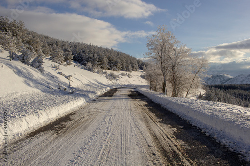 snowy and icy road in mountains on snow in winter - road safety concept - winter tires obligation, dangerous road