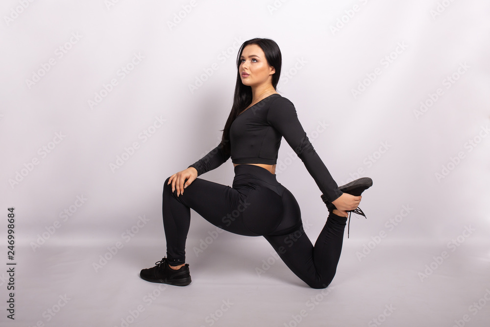 Fototapeta premium Sport women wearing sport clothes is doing exercises to build muscles. Beautiful young sporty fitness model