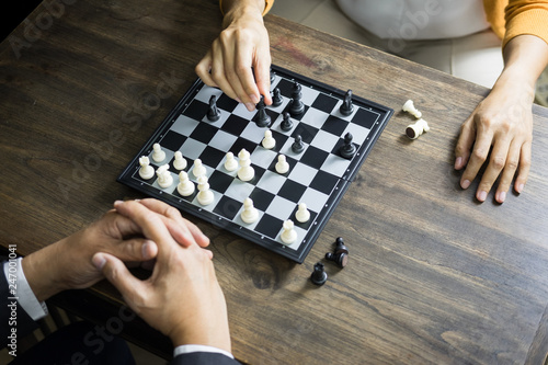 hand of businessman moving chess figure in competition board game for development analysis, strategy idea management or leadership concept.