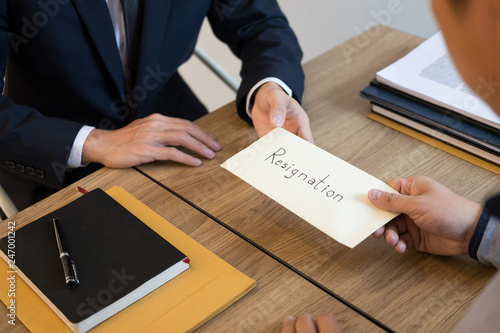 businessman hand sending a resignation letter to executive boss dismissed worker quit out from company, Change job, unemployment, resign concept