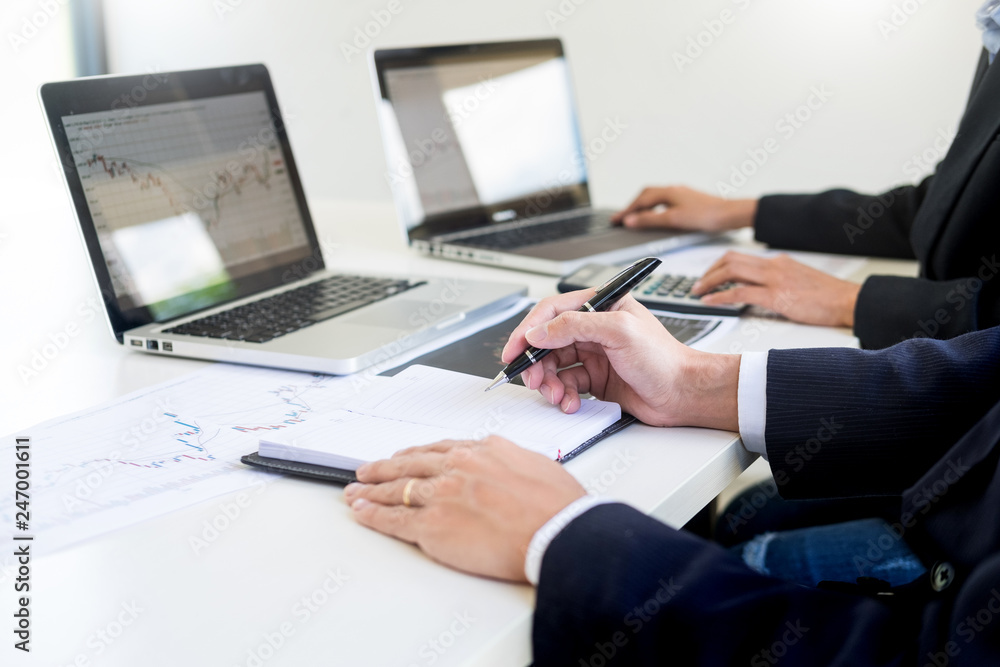 Business Team trader or broker Investment Entrepreneur colleagues working discussing and analysis graph stock market trading with forex chart data, financial, selling and buying concept Business Team trader or broker Investment Entrepreneur colleagues working discussing and analysis graph stock market trading with forex chart data, financial, selling and buying concept