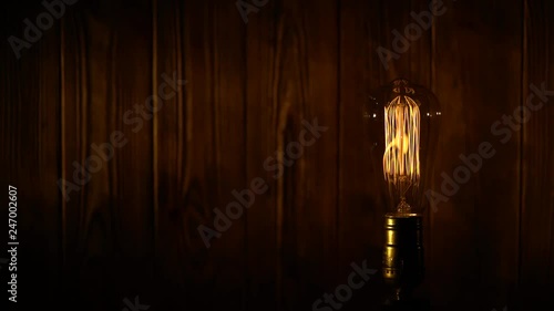Wallpaper Mural Edison light bulb on wooden background Torontodigital.ca