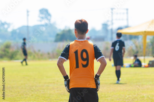 Back of young football goalie boy waiting for the ball © kudosstudio