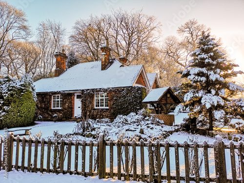 Winter snow covered village cottage in England photo