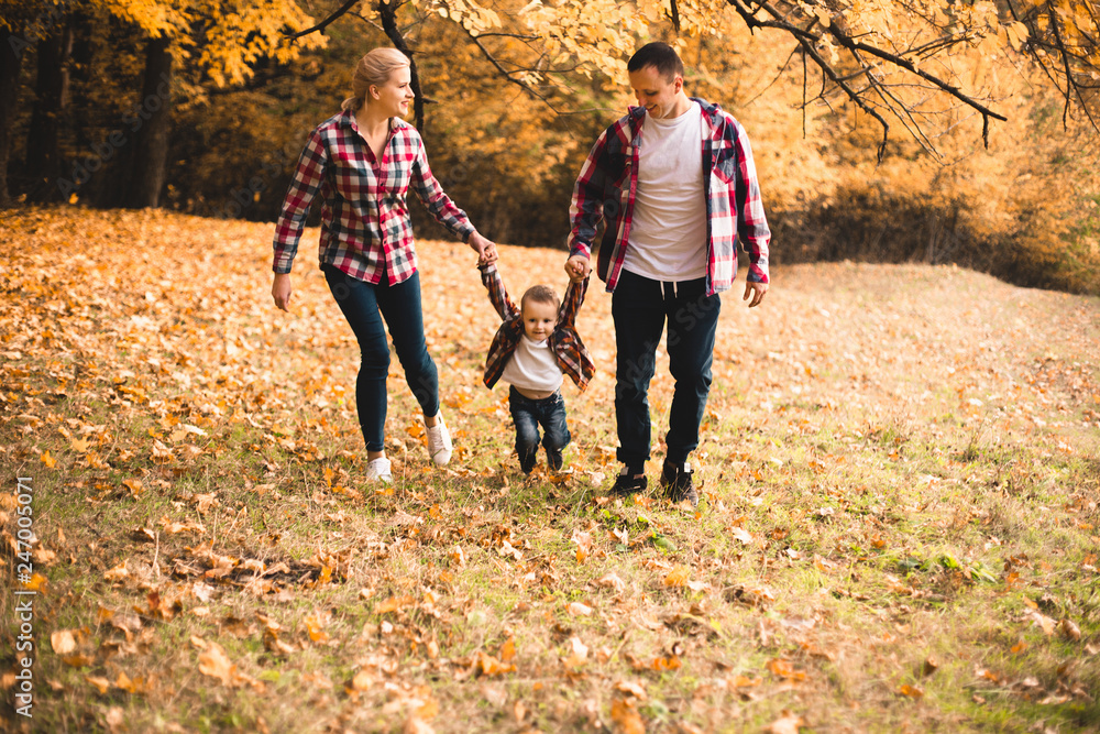 Little cute son playing with parents in forest Little cute son playing with parents in forest