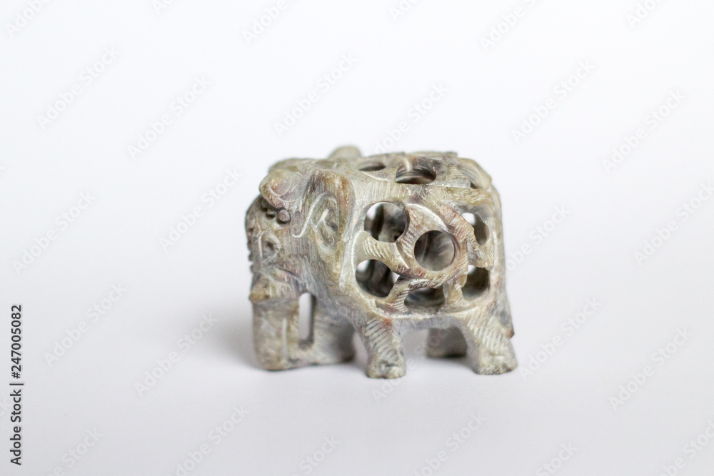 elephant, a souvenir of carved stone, on a white gray background elephant, a souvenir of carved stone, on a white gray background