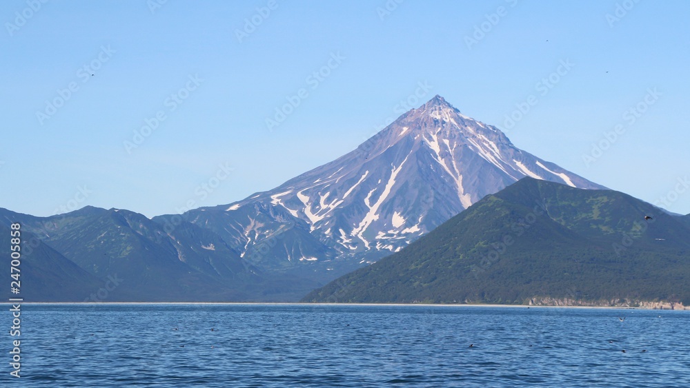 View of Vilyuchinsky volcano (also called Vilyuchik) from tourist boat. It's a stratovolcano in the southern part of Kamchatka Peninsula, Russia.