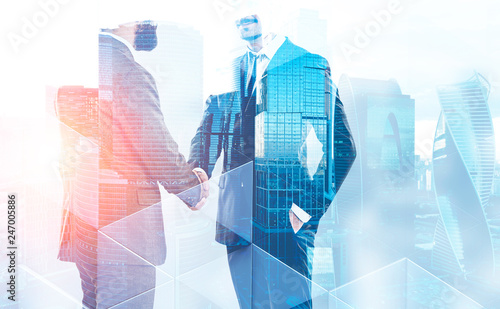 Two businessmen shaking hands in city