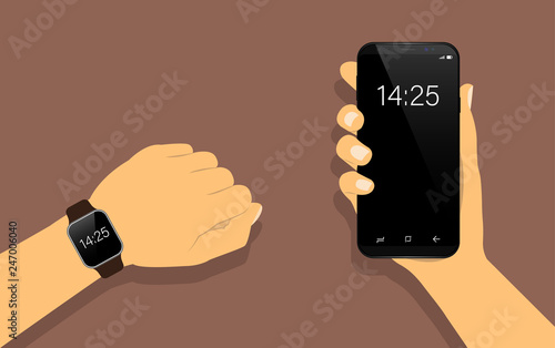 Smart watch on hand, and smartphone in hand. Communication smart watch with the phone.