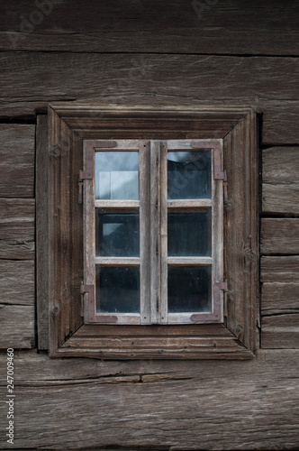 Rustic old peasant house with wooden windows