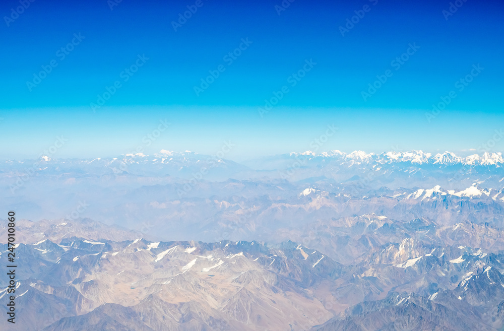 Mountains earth from aircraft under blue sky