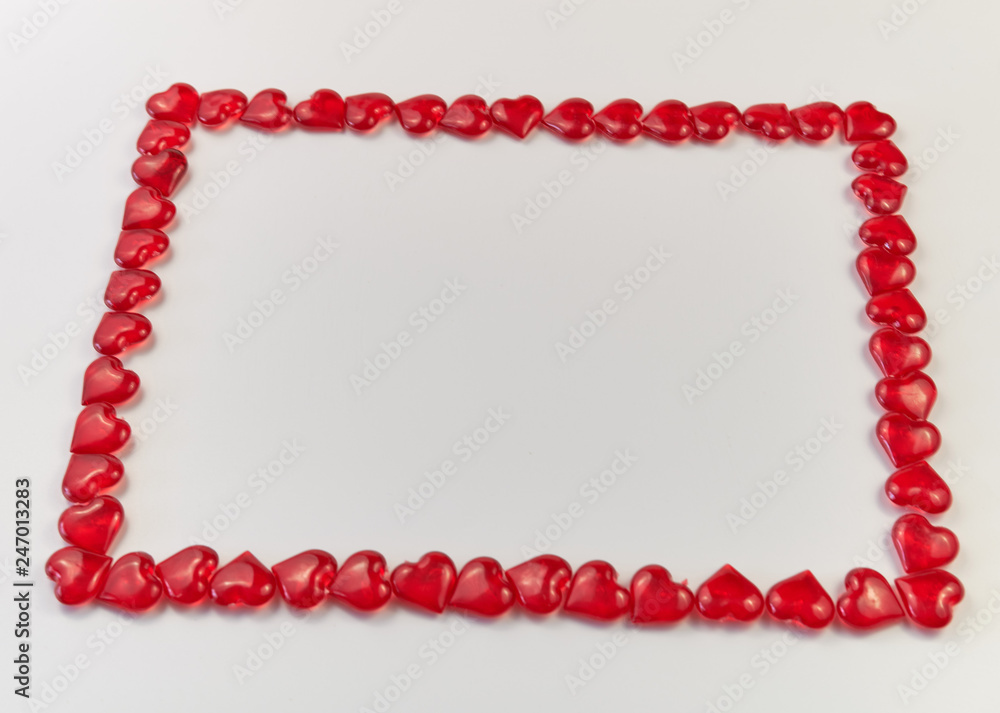Obraz premium frame lined from small glass hearts on a white background. Valentine's Day. Love symbol. copy space