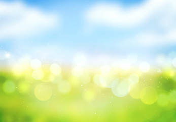 Blue sky green grass blurred bokeh background.