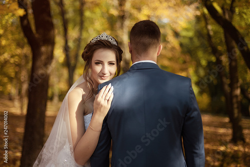 portrait of the bride on the shoulder of the groom. view from the back © tumskaia