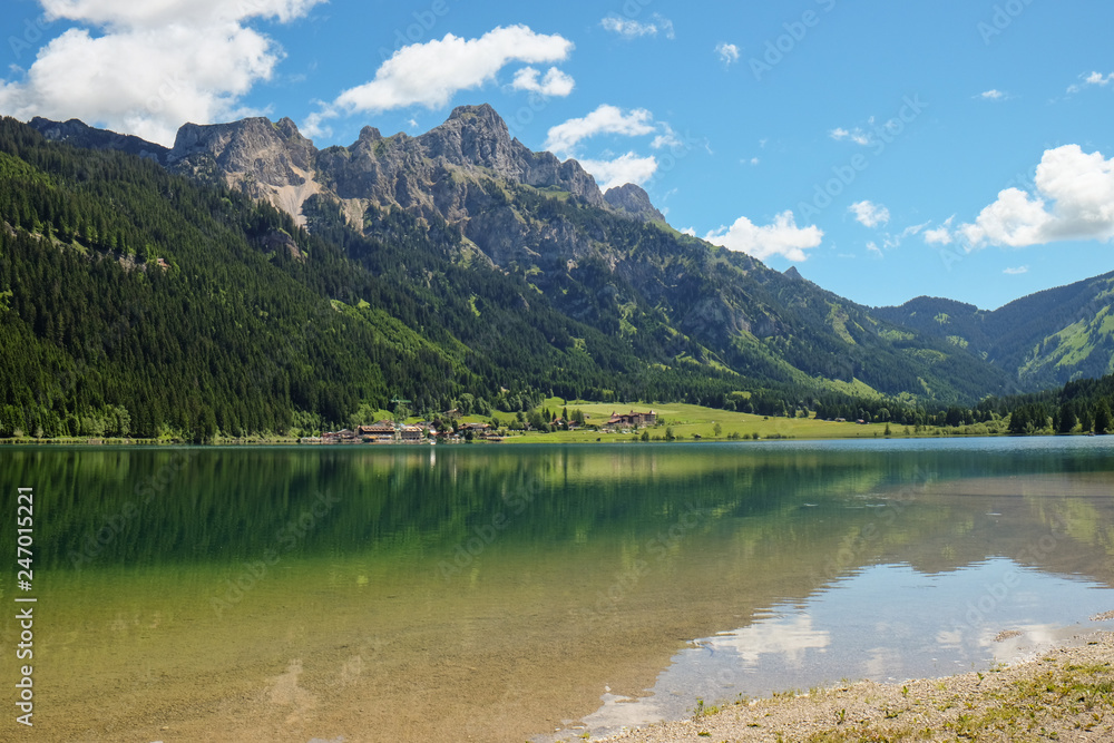 idyllic mountain landscape with a lake and mountains in the background