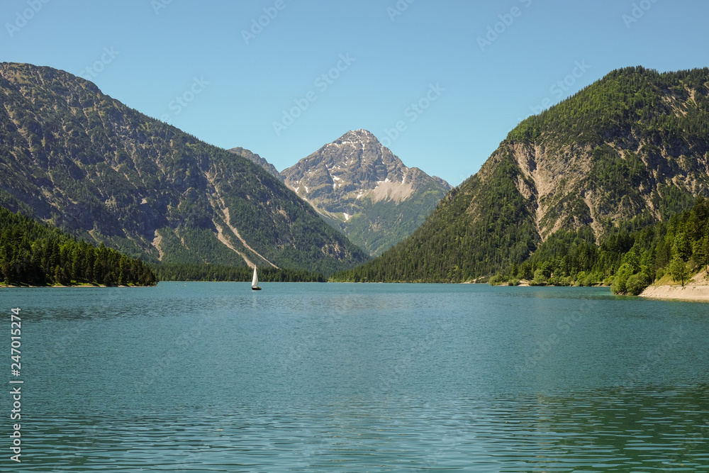 idyllic mountain landscape with a lake and mountains in the background