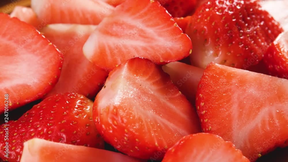 Heap of fresh sliced strawberries rotating. Closeup macro shot. Fresh berry series. Heap of fresh sliced strawberries rotating. Closeup macro shot. Fresh berry series.