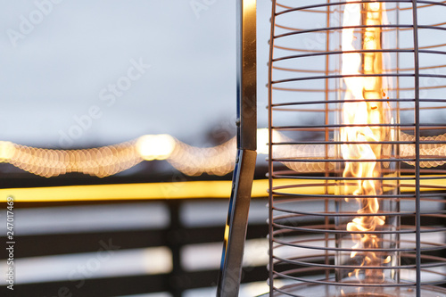 fire, warm, warms fire on the background of the city, gas lampa in a street photo