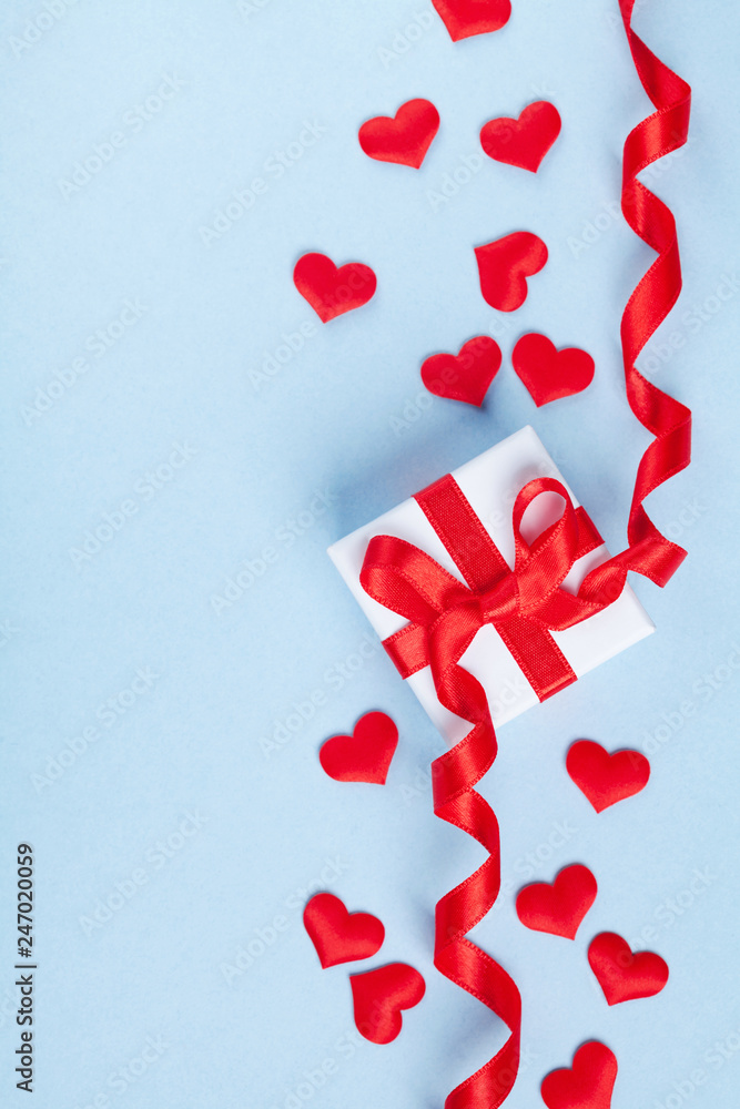 Valentine day card or banner. Gift or present box and red heart on blue background. Flat lay. Valentine day card or banner. Gift or present box and red heart on blue background. Flat lay.