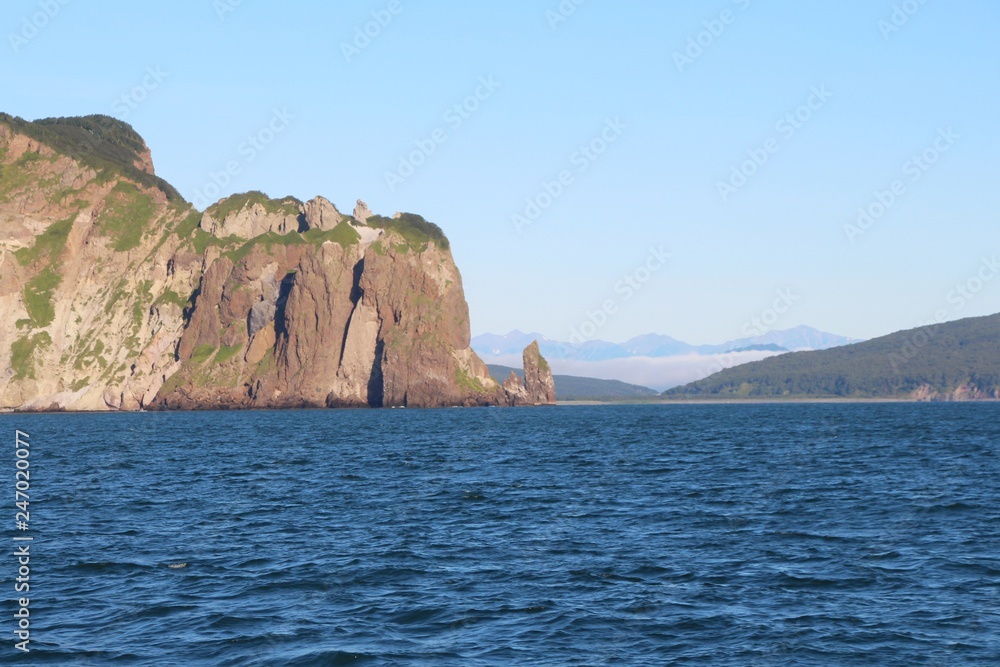 View of the coastal cliffs of the Kamchatka Peninsula, Russia. The Kamchatka peninsula contains the volcanoes of Kamchatka, a UNESCO World Heritage Site.