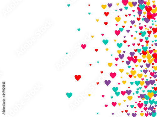 Candy of red, yellow, blue and purple hearts on a white background. Flying confetti from hearts. Valentine's day card.