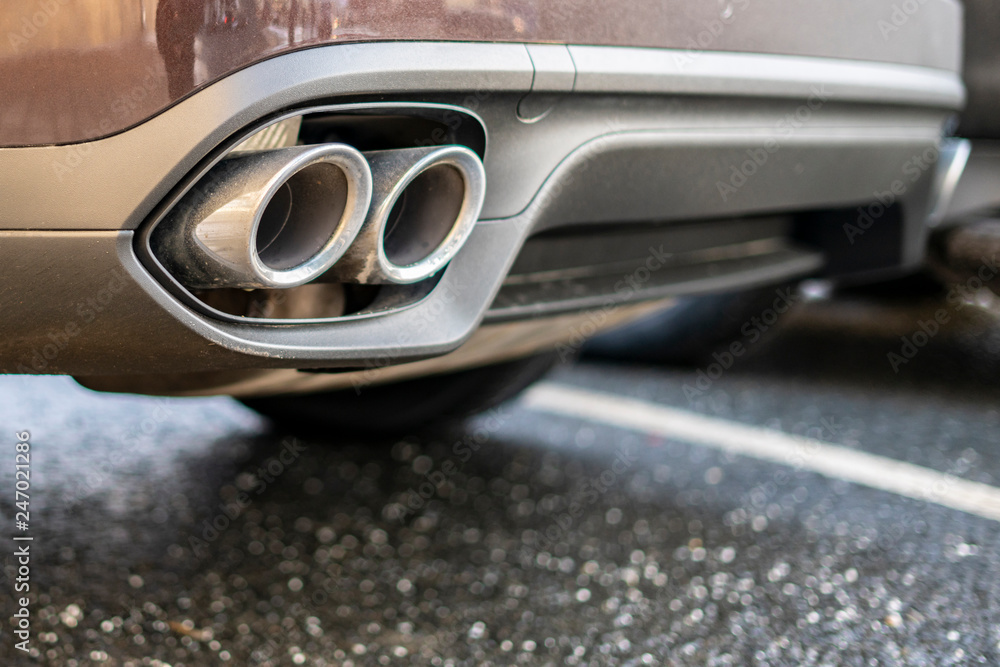 close up exaust pipe of a car releasing gas b close up exaust pipe of a car releasing gas b