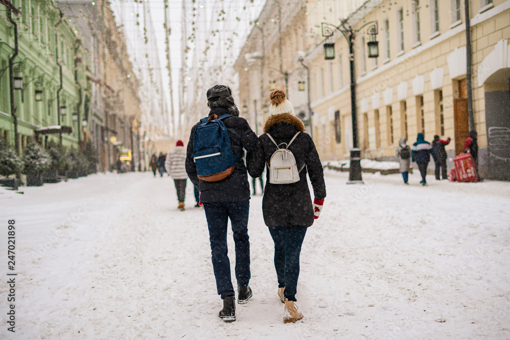 young couple enjoying walk in city streets in winter season b young couple enjoying walk in city streets in winter season b