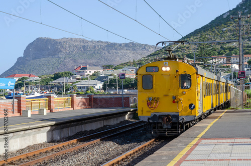 Kalk Bay, Cape Town, South Africa. Circa 2017. A yellow metro passenger train at Kalk Bay station