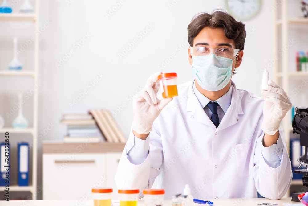 Young handsome chemist working in the lab Young handsome chemist working in the lab
