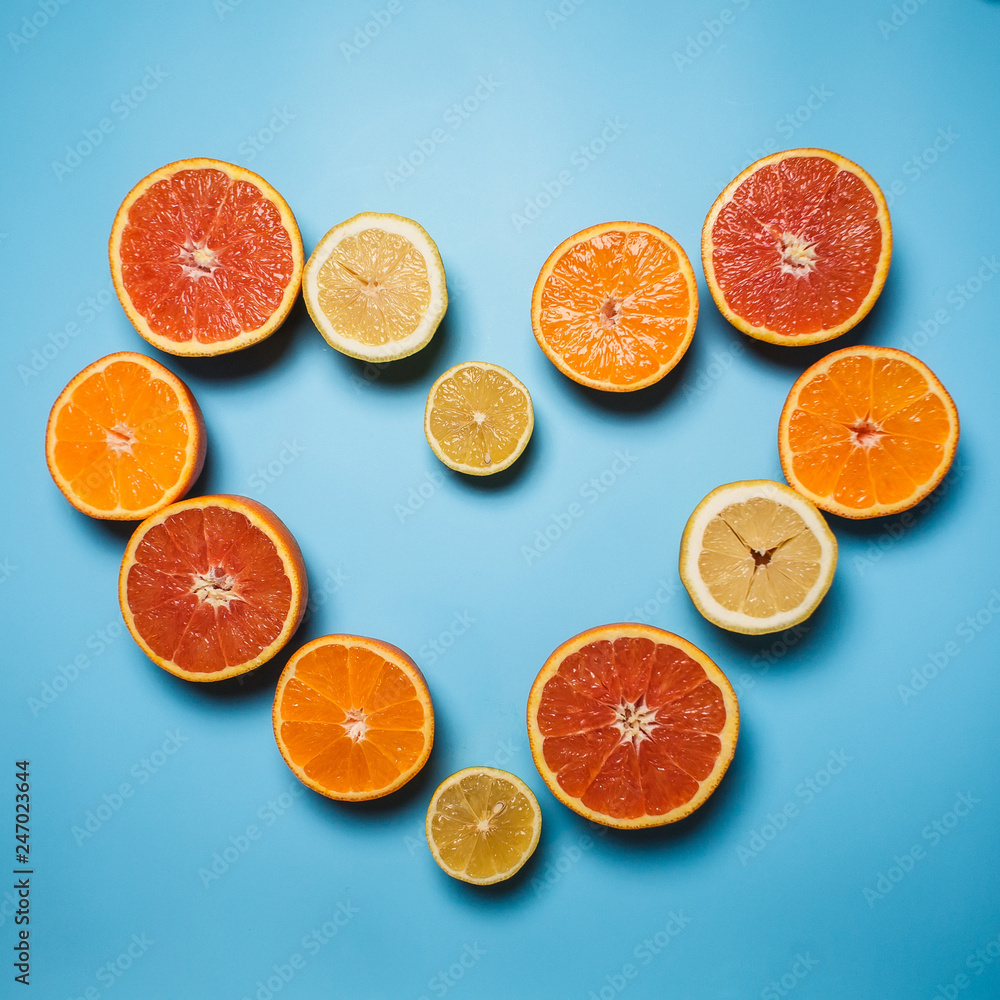 cut in half juicy citruses on a blue background which lined heart cut in half juicy citruses on a blue background which lined heart