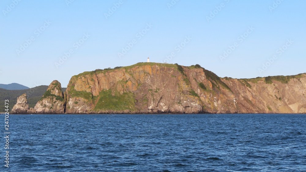 View of the coastal cliffs of the Kamchatka Peninsula, Russia. The Kamchatka peninsula contains the volcanoes of Kamchatka, a UNESCO World Heritage Site.