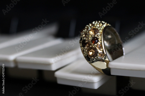 Gold ring with stones on the piano