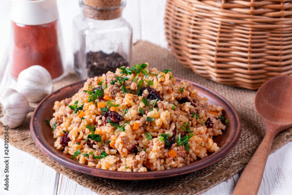 Pilaf of bulgur with meat on wooden table Pilaf of bulgur with meat on wooden table