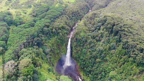 Stunning aerial drone footage of Akaka waterfall (135m tall) on the Big Island of Hawaii, USA. The waterfall is part of Akaka Falls State Park, 18km north of Hilo and is a famous tourist destination.  photo