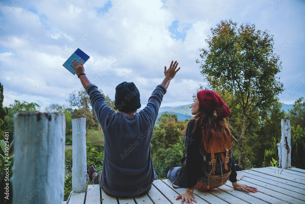 Φωτογραφία couple lover natural travel on the mountain, sitting relax reading books in the midst of nature on the white wooden bridge