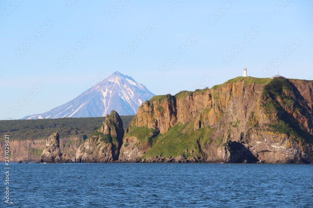 View of coastline of the Kamchatka Peninsula, Russia. In the background is visible Vilyuchinsky volcano (also called Vilyuchik).